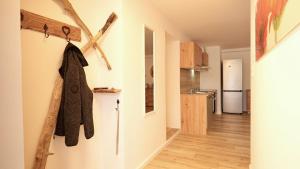 a kitchen with white walls and wooden floors at Alte Malerei in Peiting