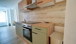 a kitchen with a stove and a counter top at Alte Malerei in Peiting