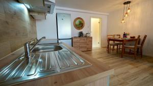 a kitchen and dining room with a sink and a table at Alte Malerei in Peiting