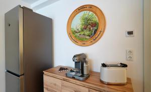 a mirror on the wall above a coffee machine on a wooden counter at Alte Malerei in Peiting +27 photos