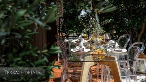 a table with glasses of wine and food on it at Private Terrace Living - Blue Flag Beach & Family Retreat near Kotor in Gornji Orahovac