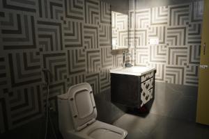 a bathroom with a toilet and a wall at Eleven Eleven Villa in Pondicherry +75 photos
