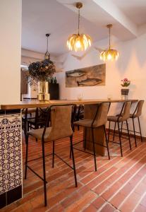 a dining room with a large wooden table and chairs at Hotel Boutique Las dos Peñas in Mier +5 photos