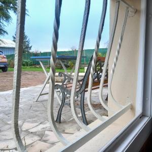 a bench sitting in front of a window at Vive le vert pomme ! in Saint-Romain-sur-Vienne