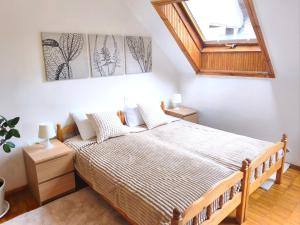 a bedroom with a bed and a skylight at Prime Location Apartment Vilnius in Vilnius