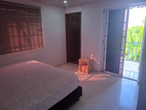a bedroom with a bed and a door to a balcony at Habitaciones Casa Lisboa in San Andrés +6 photos