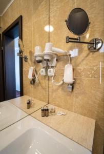 a bathroom with a shower with a phone and a sink at Marina Bay Beach Mamaia Nord in Mamaia Sat/Năvodari +53 photos