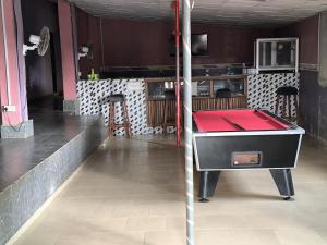 a ping pong table in a restaurant with a red top at Geobajas Hotels in Imushin
