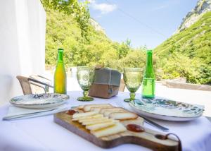 a table with a plate of food and wine bottles at Hotel Boutique Las dos Peñas in Mier