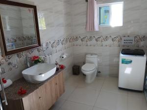 a white bathroom with a sink and a toilet at Blue Sky Self Catering in Grand Anse +41 photos