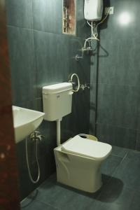a bathroom with a toilet and a sink at Chandrachhaya Agro Farms Boisar in Boisar