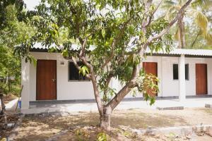a house with a tree in front of it at Chandrachhaya Agro Farms Boisar in Boisar