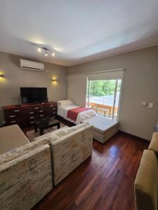 a living room with a couch and a piano at Caseros Centro Salta in Salta