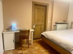 a bedroom with a bed and a desk with a chair at SomeTimes in Roeselare