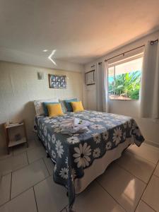 a bedroom with a bed with a blue and white blanket at Namorada Brava Guest House Praia Brava, Piscina & Naturaleza in Búzios +74 photos