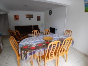 a dining room table and chairs with a table and a table and a table at Résidence EmiRose in Rivière-Pilote