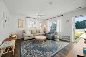 a living room with a couch and a table at The Crabby Seahorse in Emerald Isle