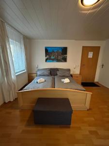 a bedroom with a large bed with two towels on it at Gästehaus Reither in Schweigen-Rechtenbach