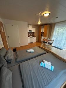 a bedroom with a large bed with towels on it at Gästehaus Reither in Schweigen-Rechtenbach +4 photos