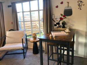 a desk and a chair in a room with a window at The Zen Nest in Geel +21 photos