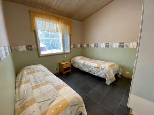 a room with two beds and a window at VILLENKUJA 1 (3 mh ) in Tahkovuori