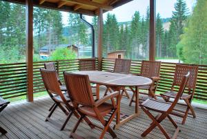 a wooden table and chairs on a wooden deck at VILLENKUJA 1 (3 mh ) in Tahkovuori