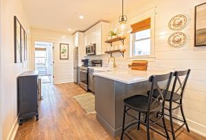 a kitchen with a counter and stools in it at Kildahl House - Boutique Farmhouse Suite #2 in West Dundee