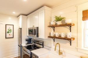 a kitchen with white cabinets and a sink at Kildahl House - Boutique Farmhouse Suite #2 in West Dundee +13 photos