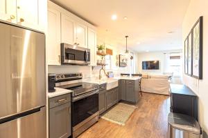 a kitchen with a stainless steel refrigerator and a sink at Kildahl House - Boutique Farmhouse Suite #2 in West Dundee