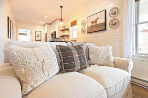 a living room with a white couch with pillows at Kildahl House - Boutique Farmhouse Suite #2 in West Dundee