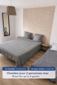 a bedroom with a large bed and a table at B&B Chambre cosy avec petit-déjeuner inclus Parking prive & box vélo sur la Route des vins in Issenheim