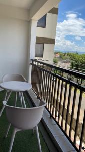 a white table and a chair on a balcony at Karibu comfort in Kisumu