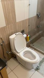 a bathroom with a toilet with the lid up at Karibu comfort in Kisumu +6 photos