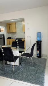 a living room with a dining table and chairs at Karibu comfort in Kisumu