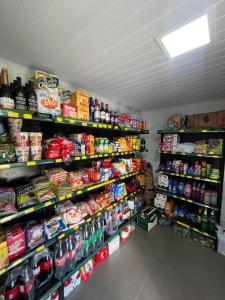a store aisle with a lot of food and drinks at Brilho do Sol in Guarapari +18 photos
