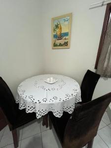 a table with a white table cloth on it at Brilho do Sol in Guarapari