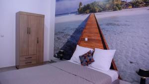 a bedroom with a bed with a picture of a pier at sempri djuntu T1A in Tarrafal