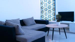a living room with a couch and a table at sempri djuntu T1A in Tarrafal