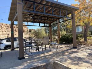 a patio with a table and chairs under a pavilion at Rustic Ridge in Granite Dells in Prescott