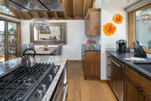a kitchen with a stove with a tea kettle on it at 63 Meadow House in Sunriver