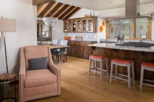 a kitchen with a bar and a table and chairs at 63 Meadow House in Sunriver