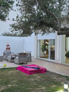 a kite laying on the ground under a tree at Villa Maya House - Cap Zbib in Banī ‘Aţāʼ