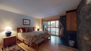 a bedroom with a bed and a sliding glass door at 62 Wildflower in Sunriver +12 photos
