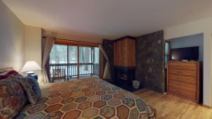 a bedroom with a bed and a large window at 62 Wildflower in Sunriver