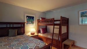 a bedroom with two bunk beds and a lamp at 62 Wildflower in Sunriver