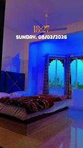 a bedroom with a bed in a blue room at Hotel om banna in BhÄdura +9 photos
