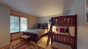 a small bedroom with a bunk bed and a bunk bed at 62 Wildflower in Sunriver