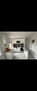 a kitchen with white cabinets and a counter top at Sun argeles sur mer in Argelès-sur-Mer