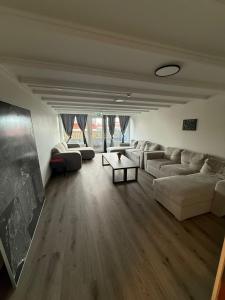 a living room with white couches and a table at Whale House in Keflavík