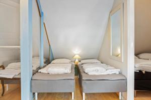 a row of beds in a room with a mirror at LN2056-Hjorring-Strandvejen-56 in Lønstrup